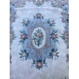 Chinese wash rug with floral decoration on cream and blue ground, 274cm x 186cm