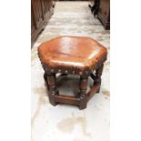 Oak hexagonal stool with studded leather top on turned and block legs joined by stretchers, together