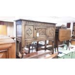 Seventeenth century style oak sideboard with carved decoration and panelled door on turned and block