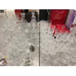 Large quantity of glassware including cut glass wines, champagne flutes, decanters etc