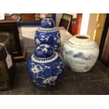 Two Chinese blue and white prunus jars and covers, and another Chinese blue and white jar (2)