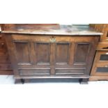 Eighteenth century oak coffer with hinged lid and panelled front, raised on square feet, 128cm wide,