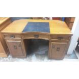 Early 20th century oak kneehole desk with three drawers and two cupboards below, 128cm wide, 81.5cm