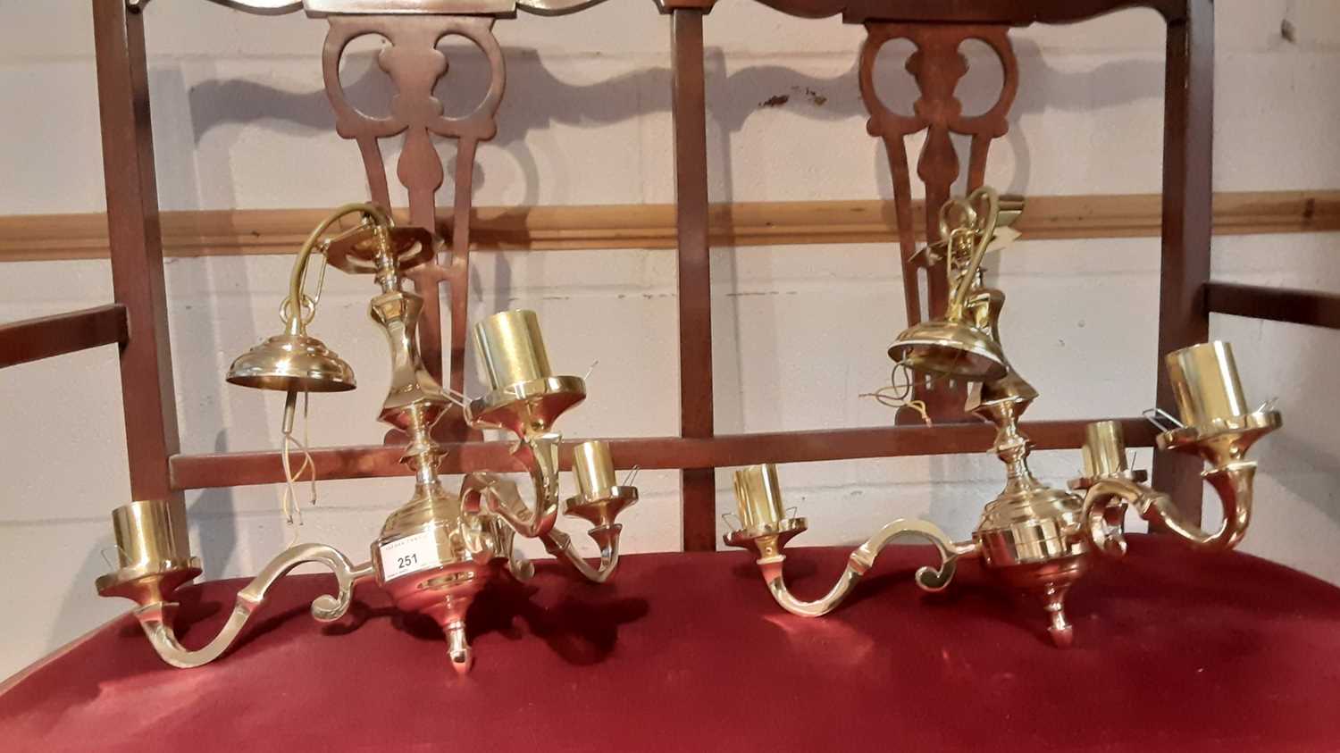 Pair of brass three branch ceiling lights