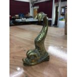 A heavy brass doorstop in the form of a mythical dolphin, 25.5cm high