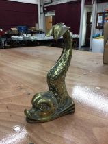 A heavy brass doorstop in the form of a mythical dolphin, 25.5cm high