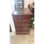 Reproduction mahogany filing cabinet with inset leather top.