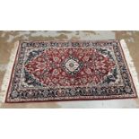 Eastern rug with floral decoration on red, blue and cream ground, 150cm x 89cm