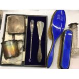 Two silver and blue enamel brushes, silver cigarette case, silver mug, silver topped glass vase and