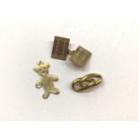 One 9ct gold cufflink, gold bear charm stamped 14k and two 18ct gold chain links