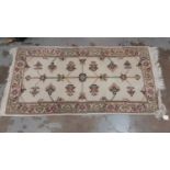 Modern cream rug, 125cm x 63cm, together with another on red and beige ground, 170cm x 122cm