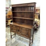 1920's/30's oak two height dresser with open shelves above two geometric panelled doors below on bo