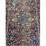 Eastern rug with floral decoration on red and blue ground, 200cm x 138cm