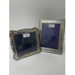 Contemporary silver mounted photograph frame with scroll foliate border, together with another silve
