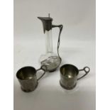 Art Nouveau pewter mounted decanter and two German pewter cups