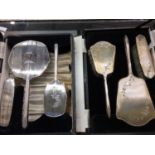 Two cased silver backed dressing table brush and mirror sets