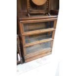 Early 20th century oak three tier Globe Wernike bookcase with drawer below, 87cm wide, 27cm deep, 11