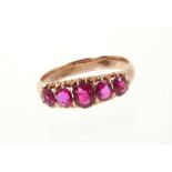 Victorian ruby five-stone ring with five graduated oval mixed cut rubies in gold claw setting on gol