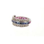 A ruby, sapphire and diamond eternity swivel ring, the main band channel set with calibré cut blue s