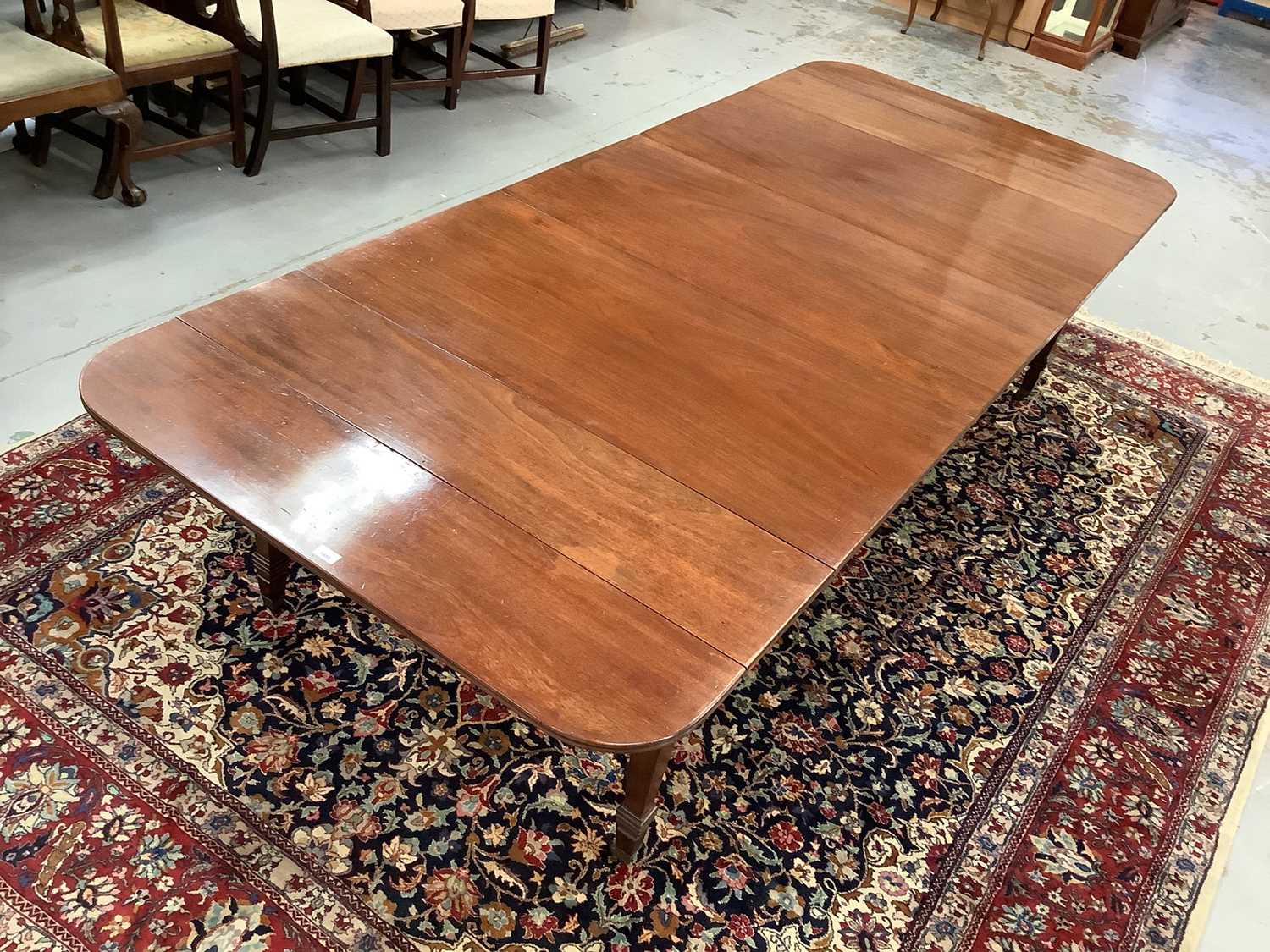 19th century mahogany concertina action extending dining table with three extra leaves