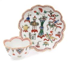 A Chinese famille verte tea bowl and saucer, Kangxi period, decorated with precious objects and ausp