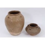 Two early Chinese glazed pots with lugs around the shoulders