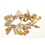 9ct gold charm bracelet with a collection of twenty-six various carat gold and yellow metal charms