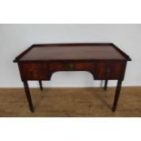 Regency mahogany dressing table, with galleried top and three drawers to the shaped frieze on ring t