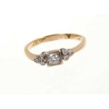 Diamond ring with a central brilliant cut diamond flanked by diamond shoulders