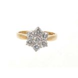 Diamond cluster ring with a daisy cluster of seven brilliant cut diamonds in claw setting on 18ct ye