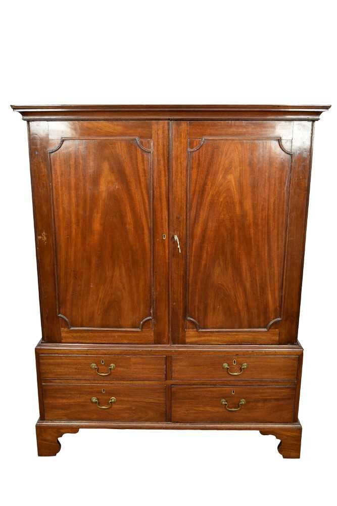 George III mahogany linen press, with concave moulded cornice and interior of slides enclosed by pai