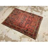 Sarouk rug, with angular geometric floral ornament on brick red ground, in main foliate border with