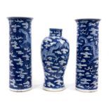 A garniture of late 19th century Chinese blue and white porcelain vases, each decorated with dragons