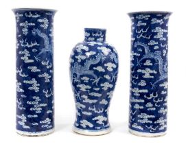 A garniture of late 19th century Chinese blue and white porcelain vases, each decorated with dragons