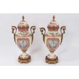 A pair of 19th century Sevres style ormolu-mounted twin-handled vases, decorated with figural and la