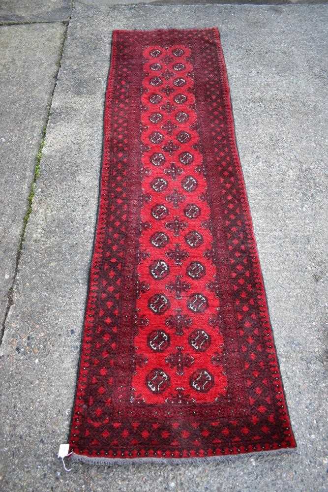 Pakistani belouche runner, with fourteen rows of quartered medallions in geometric borders, 293 x 79