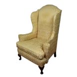Early 20th century wing armchair with gold upholstery