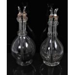 An unusual pair of French glass decanters, each internally divided into four parts, with individual