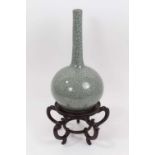 An Oriental celadon crackle glazed bottle vase