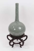 An Oriental celadon crackle glazed bottle vase