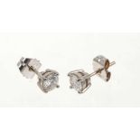 Pair of diamond stud earrings, each with a round brilliant cut diamond in four claw setting with pos