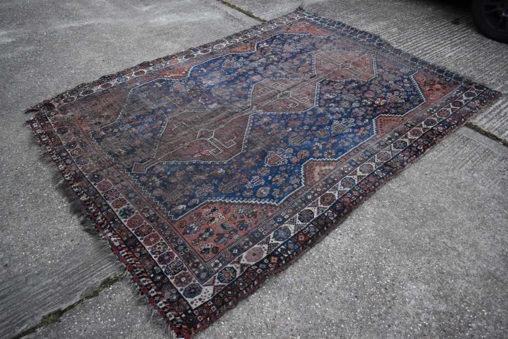 Shiraz rug with midnight blue ground and three conjoined medallions