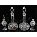 A pair of Webb cut glass shaft and globe decanters, 31cm high, together with a pair of small silver