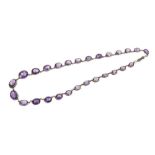 Amethyst rivière necklace with 27 graduated oval mixed cut amethysts in silver collet setting