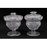 A near pair of 19th century cut glass covered vases, with cross-hatched and diamond pattern, fan-pat