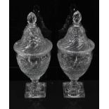 A pair of Regency cut glass covered urns or bonbonnieres, with bands of fluting, diamond and foliate
