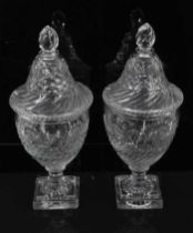 A pair of Regency cut glass covered urns or bonbonnieres, with bands of fluting, diamond and foliate