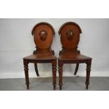 Pair of Victorian mahogany hall chairs