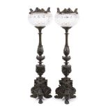 Pair of 19th century bronze candlesticks converted for electricity, each with inverted cut glass bow