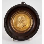19th century gilt copper medallion depicting Louis XVIII, in ebonised wood frame